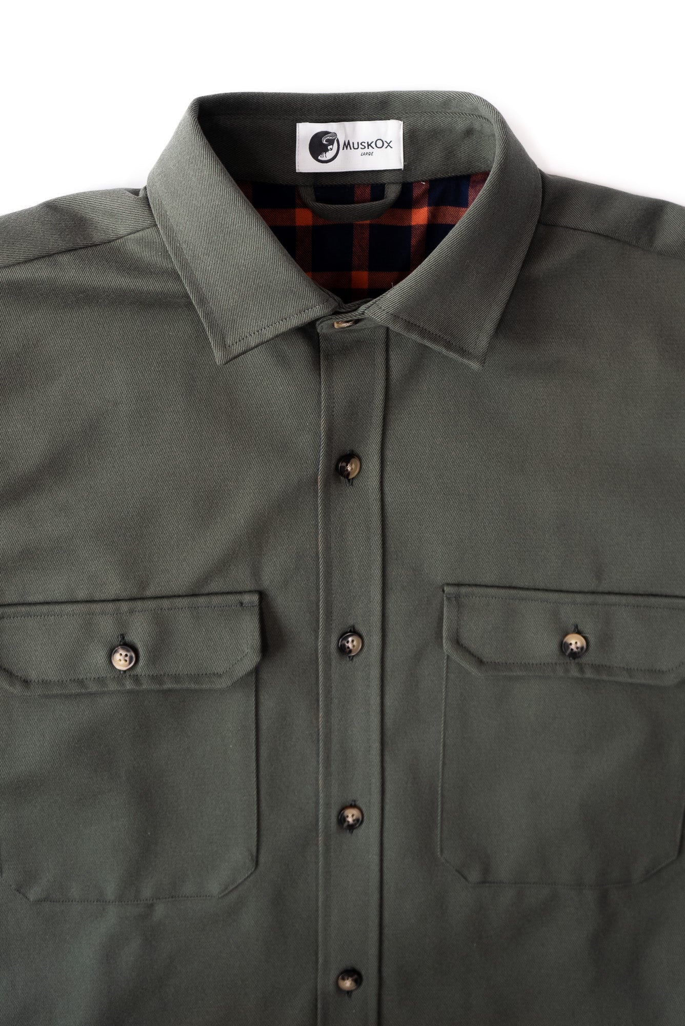 Green shirt with plaid lining on a white background