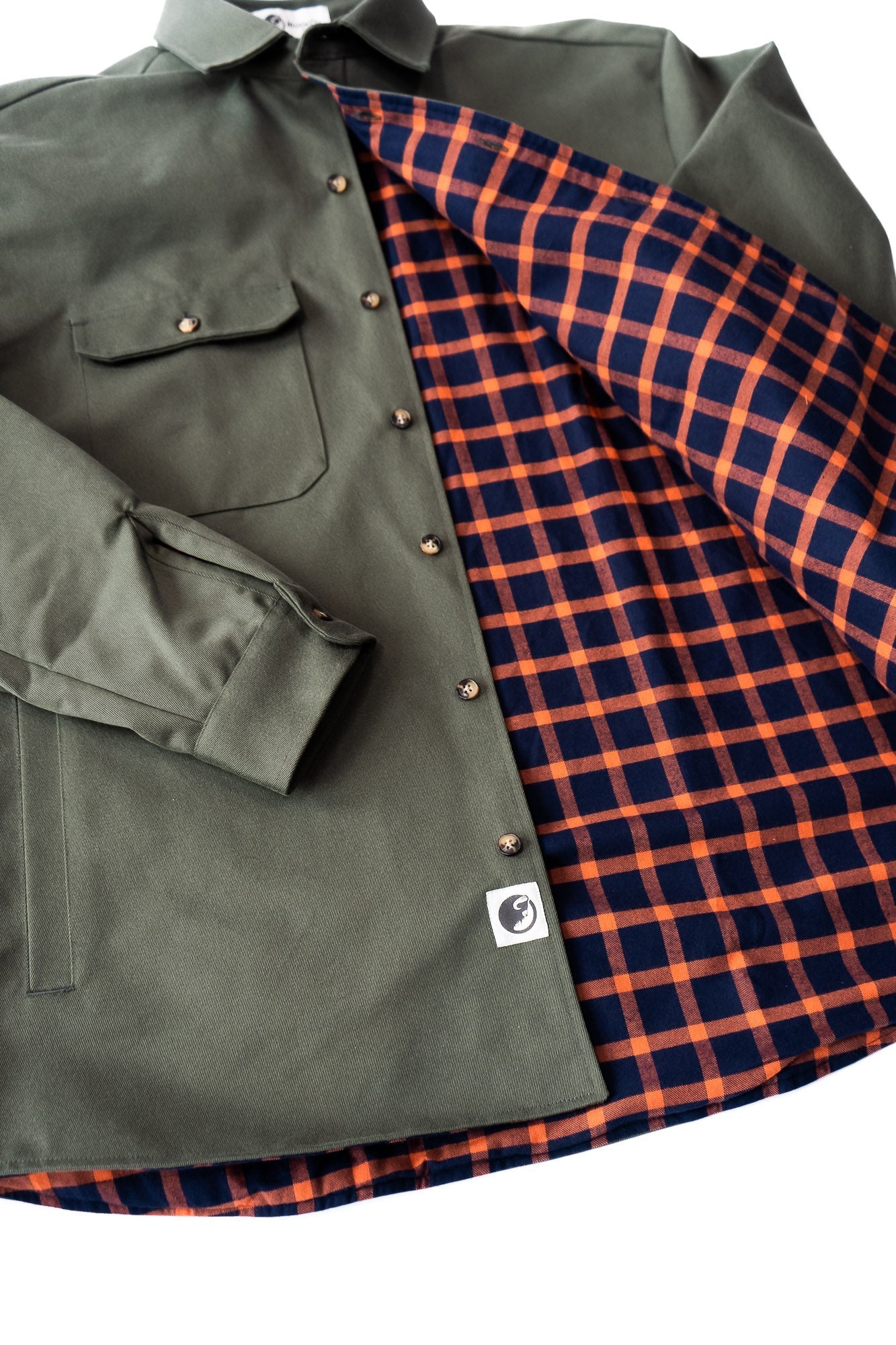 Green jacket with plaid lining on a white background
