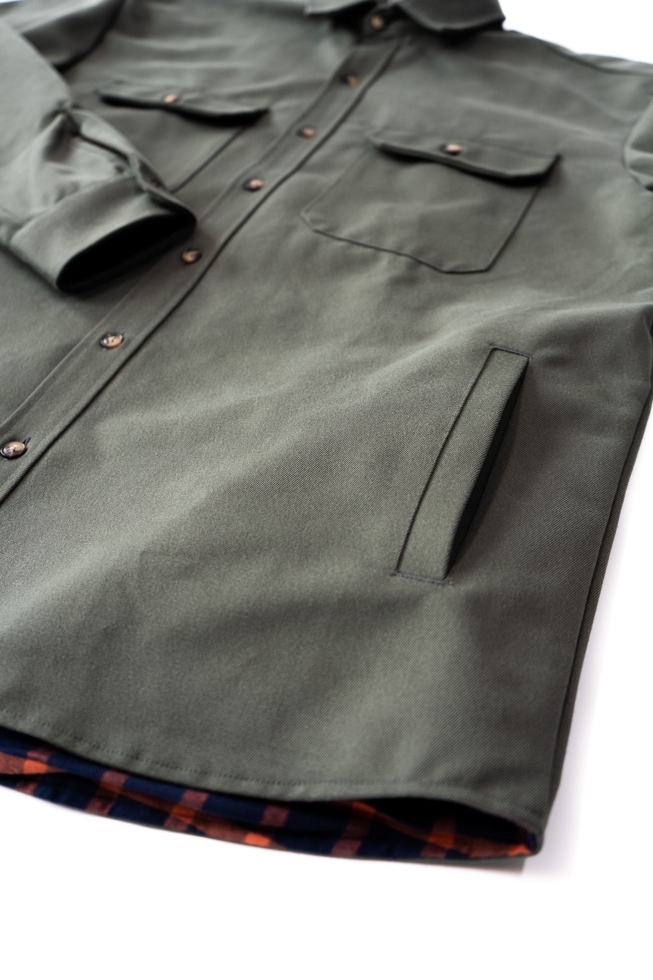 Green jacket with plaid lining on a white background